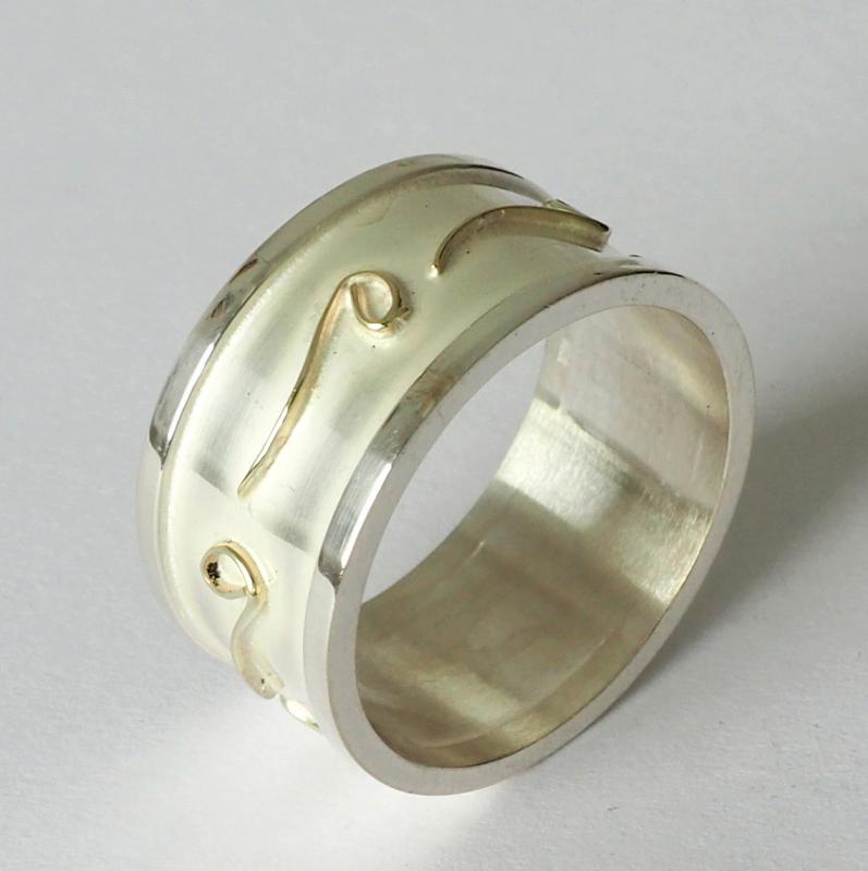 Massieve zilveren ring met gouden ornamenten. 